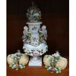 A FLORAL PUTTO HANDLED PEDESTAL VASE & COVER together with a pair of floral encrusted and putto