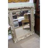 A LARGE MODERN RECTANGULAR BEVELLED PLATE WALL MIRROR in painted cast frame