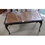 A REPRODUCTION MAHOGANY FINISHED RECTANGULAR COFFEE TABLE on four slender cabriole legs