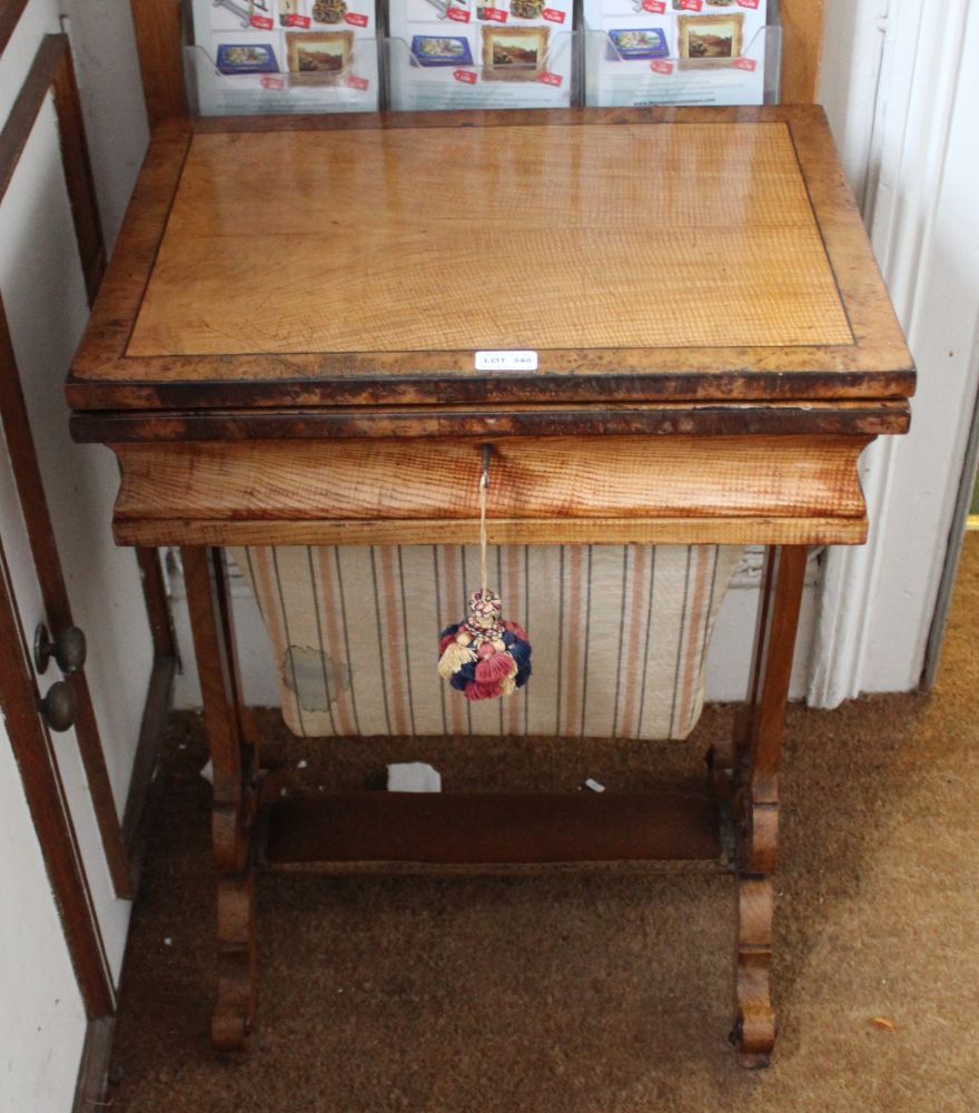 A MID-TO LATE VICTORIAN MIXED WOOD CARD/WORKTABLE having revolving fold out baize lined lid, over