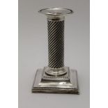 A LATE 19TH CENTURY SILVER CANDLESTICK, reed twist column on a square stepped base, Birmingham 1890,