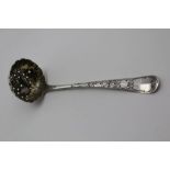 A GEORGE II SILVER SUGAR SIFTING LADLE, the bowl fruit repousse decorated & internally gilded,