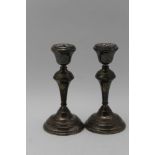 W I BROADWAY & CO A pair of silver candlesticks, on circular platform bases, Birmingham 1972, 18cm