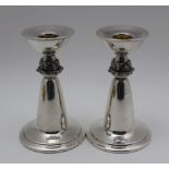 DAVID LAWRENCE, A PAIR OF ARTS & CRAFTS DESIGN SILVER CANDLESTICKS, the stems cast with a Celtic