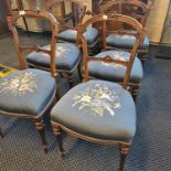 A set of six late 19th century walnut dining chairs in turned and fluted legs with blue