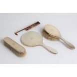 A silver brush set including hairbrush, comb and mirror, with marks for London 1951 and Carrington &