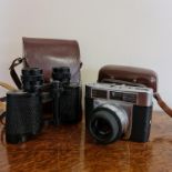 A Zeiss Ikon camera in case with a pair of Zeiss Jena Jenoptem binoculars in case. Important: Online