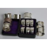 Seven various silver napkin rings, with a set of six napkin rings engraved 'WJM' and 7-12, in