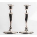 A pair of silver weighted candlesticks, with marks for Sheffield 1920 and David & Maurice Davis.