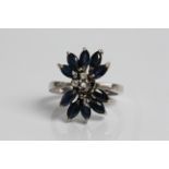 A white gold sapphire and diamond cluster ring, marked 18k, ring size K1/2, approx weight 4.43gms.