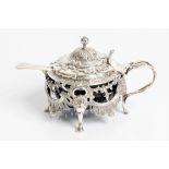 A silver early Victorian salt pot with decorative hinged lid and fret work body on four cabriole