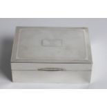 A silver cigarette box with wooden interior and engine turned top, engraved 'R.D.C. FROM A.P. 28-2-