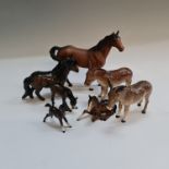 Two Beswick donkeys, three foals, one pony and a horse. IMPORTANT: Online viewing and bidding