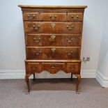 A Georgian walnut chest of three long and six short drawers on four Queen Anne style legs with