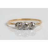 A three stone diamond yellow gold ring, marked 18ct and platinum, total diamonds 0.50 cts. ring size