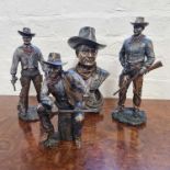 Four John Wayne bronze effect figures in Western costume. IMPORTANT: Online viewing and bidding