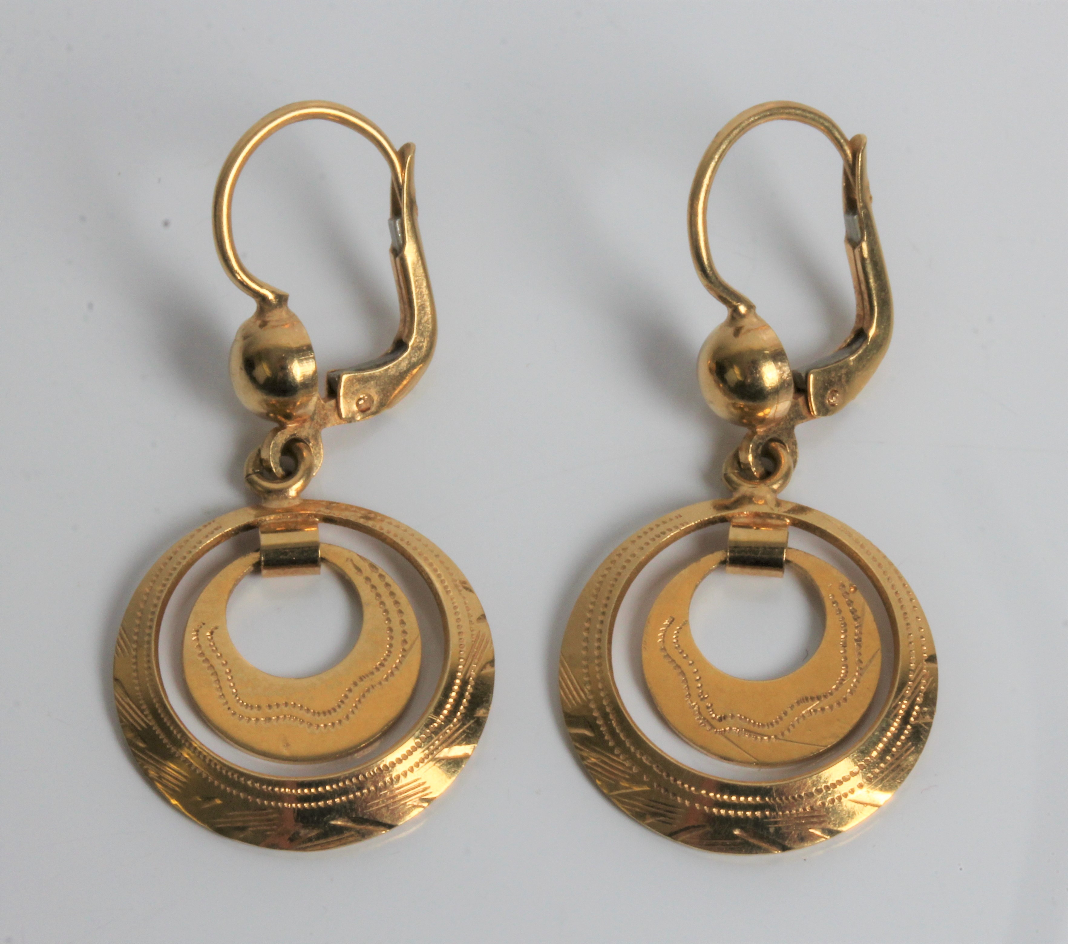 A pair of circle dropper earrings, marked 18ct gold, approx. weight 4.6gms. Important: Online