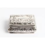 A silver decorative snuff box decorated with rural scenes to top figures in a field to base cow with