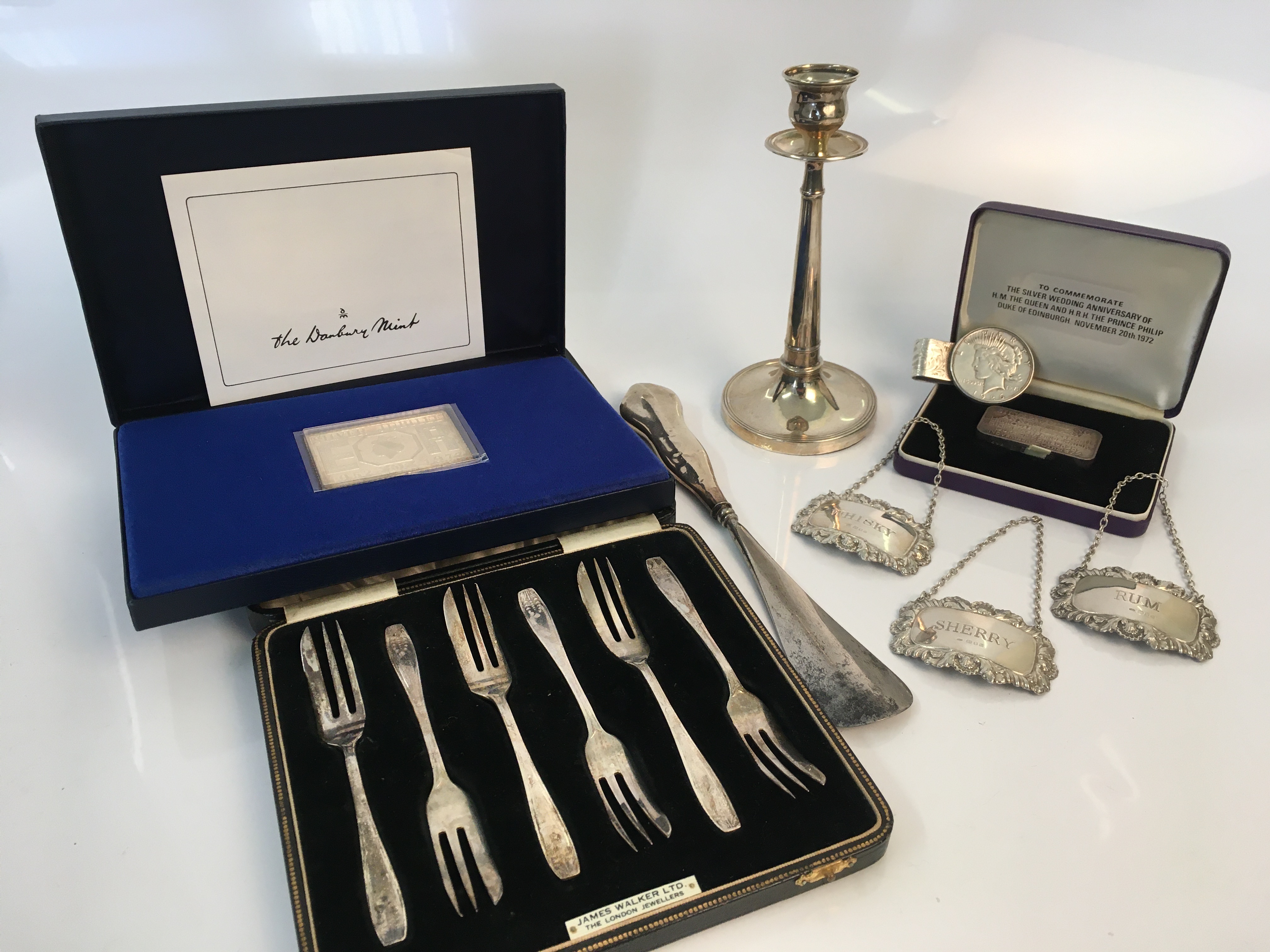 A collection of various silver including ingot commemorating Elizabeth II silver wedding