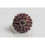 A yellow gold tiered pink sapphire cluster ring, marked 14k, ring size K, approx. weight 5.1gms.