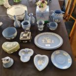 A selection of various Wedgwood jasperware, on blue, black and green backgrounds, including vases,