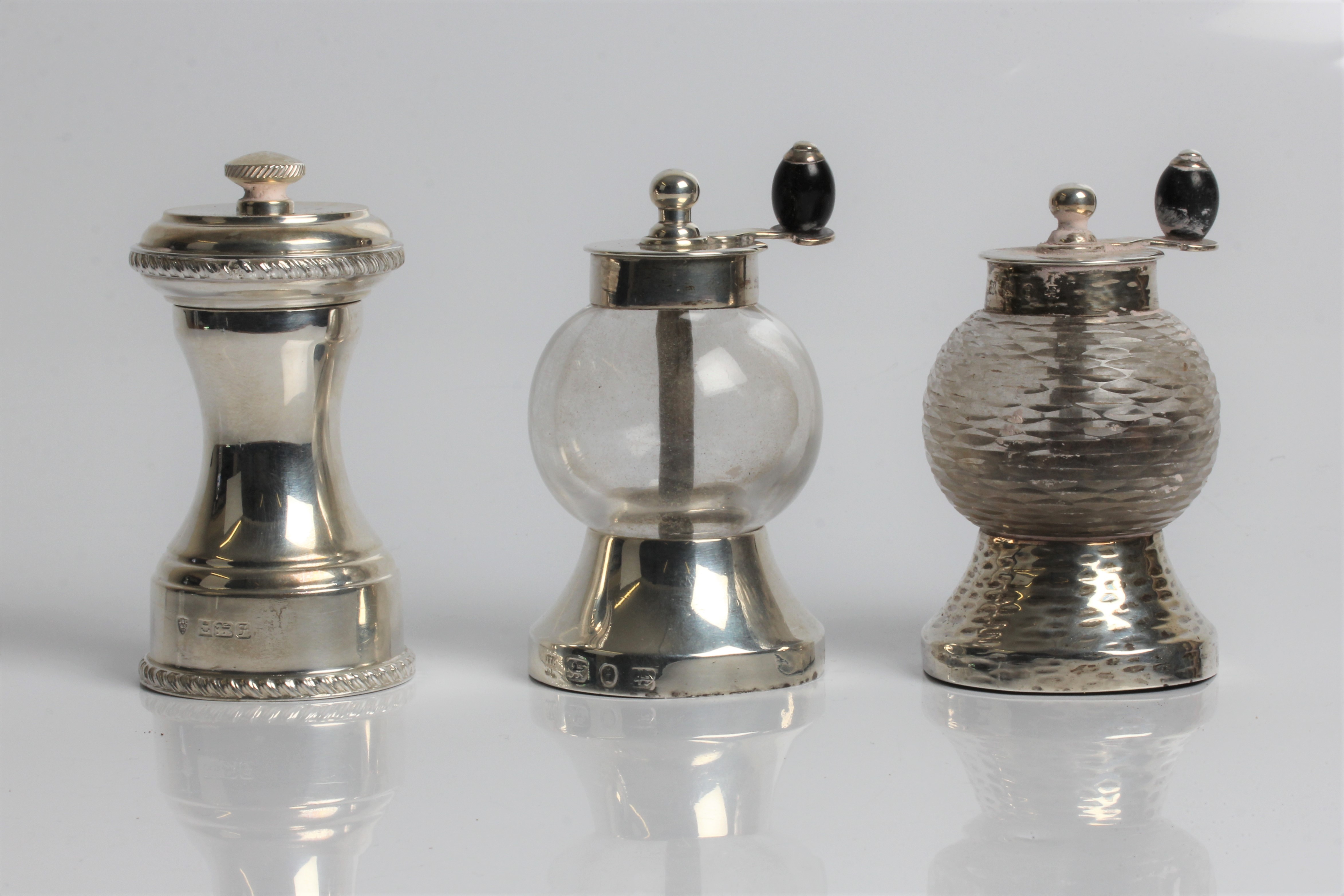 Silver and glass salt and pepper mills, with marks for Birmingham 1896 and Hukin & Heath, 9cm x