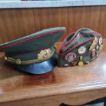 Two Russian military hats with badges. Important: Online viewing and bidding only. No in person