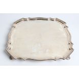 A silver tray with pie crust edge and antelope head engraved to front, with marks for Sheffield 1929