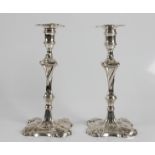 A pair of George II cast candlesticks marks for London 1763 and Ebenezer Coker with detachable