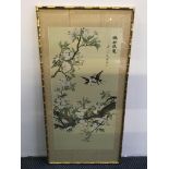 A framed Chinese painting on silk, two birds surrounded by cherry blossom tree, 98cm x 50cm.