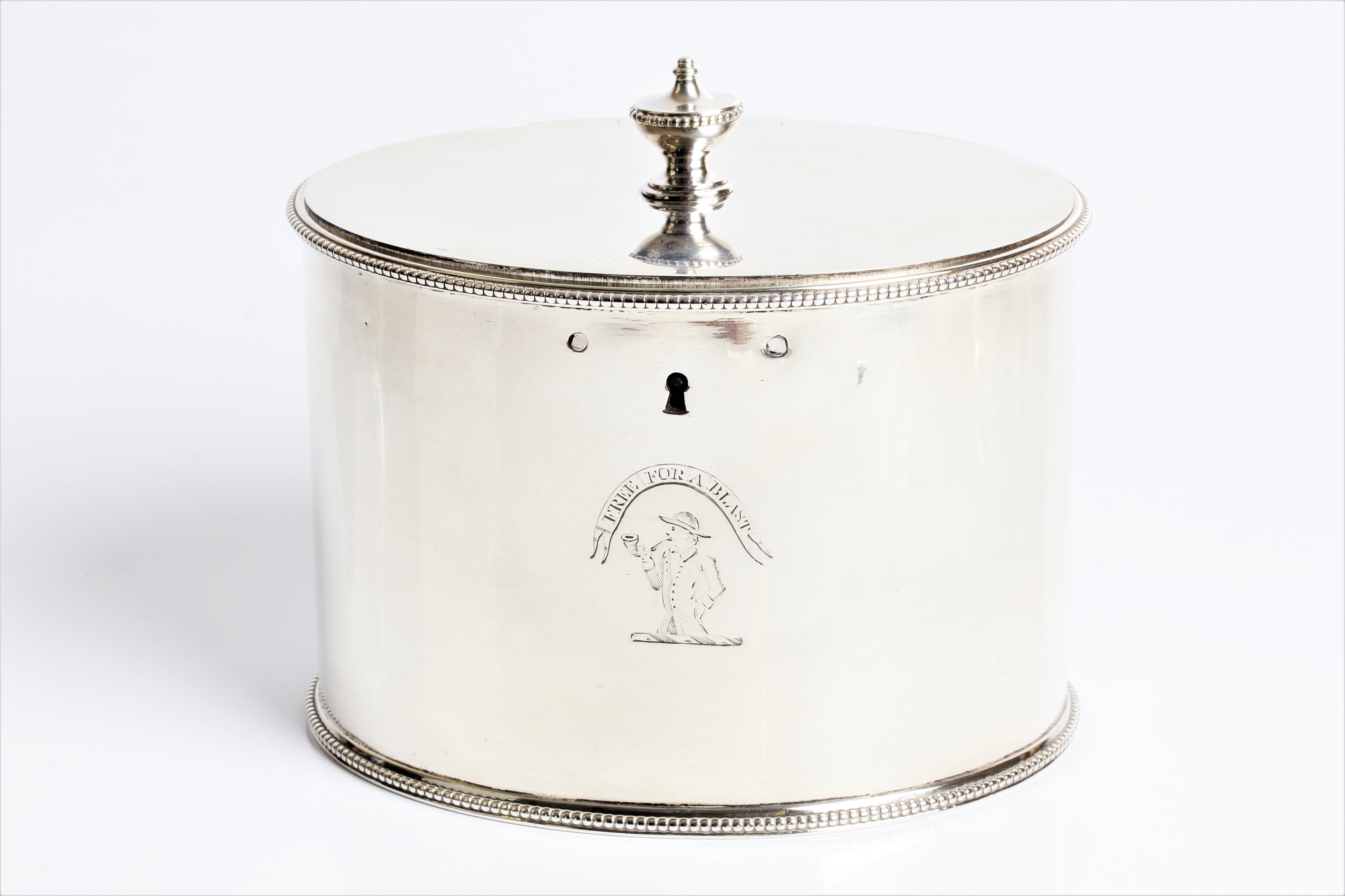 A George III silver tea caddy of plain oval form with urn finial to top, lock and original key, with