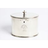 A George III silver tea caddy of plain oval form with urn finial to top, lock and original key, with