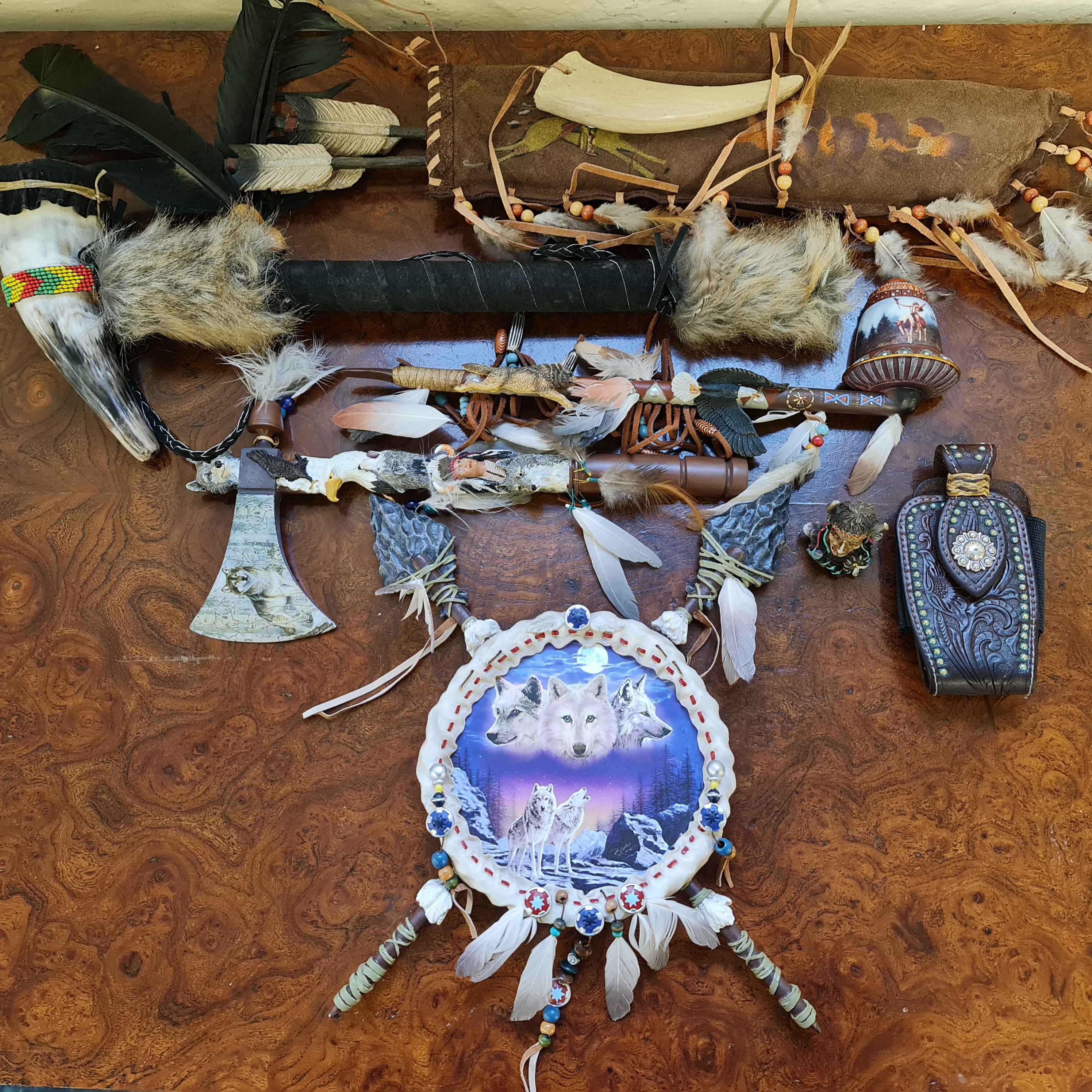 A collection of Native American related items including a war dance rattle, a quill and arrows,