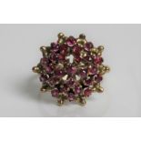 A yellow gold pink sapphire flower design cluster ring, marked 14K, ring size N 1/2, approx.