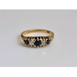An 18ct yellow gold Victorian five stone sapphire and diamond ring, set with three round cut