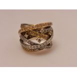 A hallmarked 18ct white, yellow and rose gold diamond multi-band cross over design ring, set with