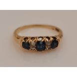 A sapphire and diamond ring, set with three oval cut sapphires separated by four rose cut diamond