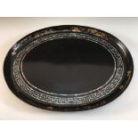 A lacquered tray with mother of Pearl inlay and gold painted design to edges, 59.5cm x 47.5cm.