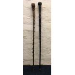 A folk art walking stick together with an ebonised walking stick with bone inlay. IMPORTANT: