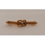 A seed pearl bar brooch with rope twist design, stamped '15c ARAT', length approx. 5cm, weight