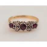 A ruby and diamond ring, set with three round cut rubies separated by four single-cut diamonds,