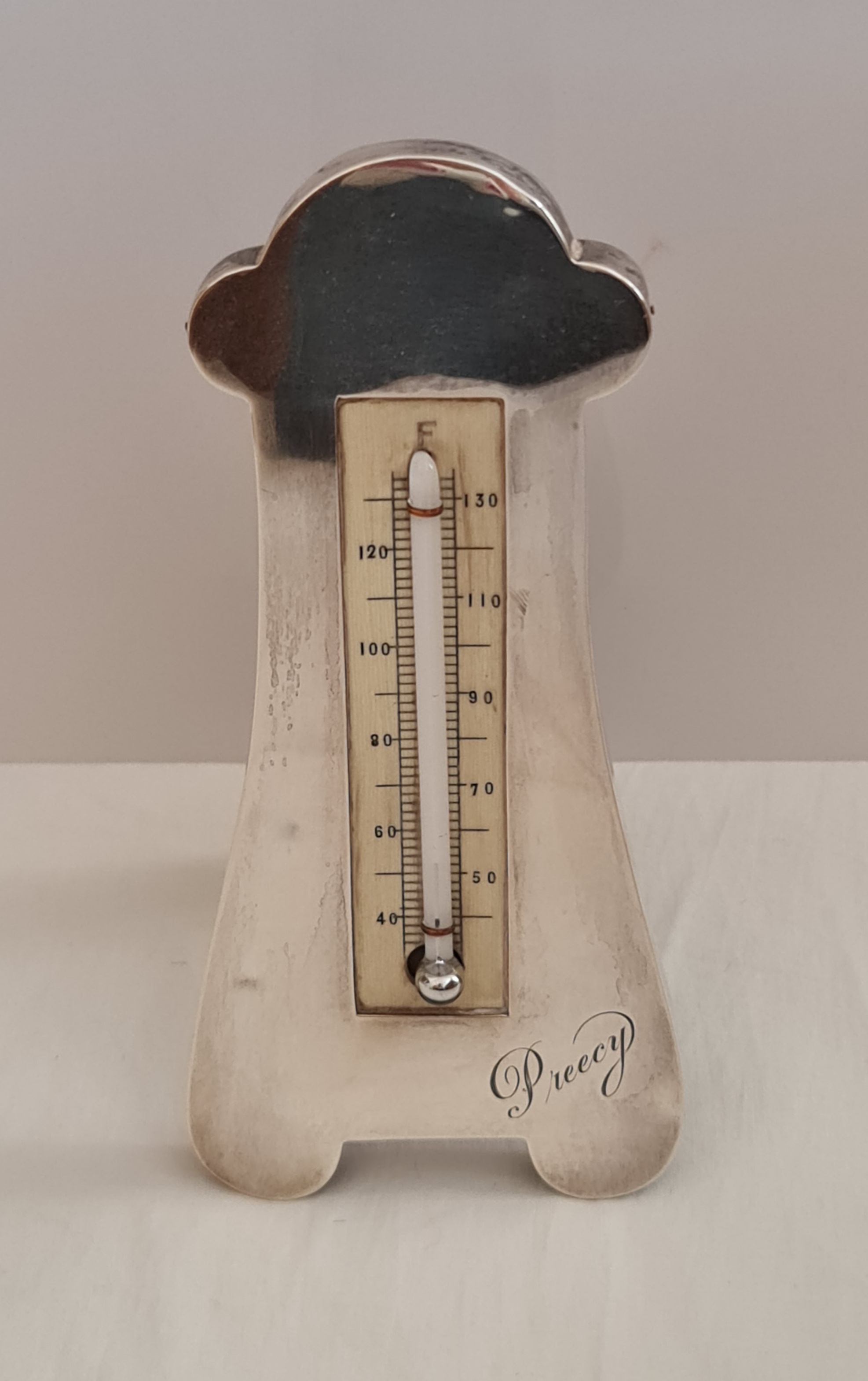 An Edwardian silver framed thermometer, featuring personal engraving, thermometer mounted in ivory