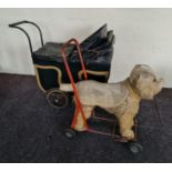 Toy pull along dog on wheels and black four wheel covered pram. IMPORTANT: Online viewing and