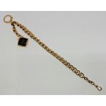 A fancy curb link watch chain, with attached black hardstone cameo fob, indistinctly stamped (