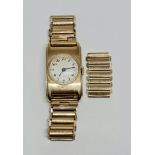 A 9ct yellow gold cased wrist watch, the silver-tone dial having hourly Arabic numeral markers,