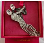 A Butler & Wilson brooch featuring two figures dancing, measuring approx. 13x6cm, in box. IMPORTANT: