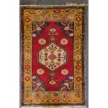 A large Afghan rug with blossom and fruit pattern corners and burnt orange border, 166cm x 94cm.