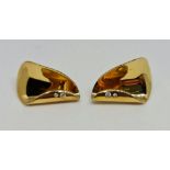 A pair of hallmarked 18ct yellow gold diamond clip-on earrings, the cotemporary fold over design set