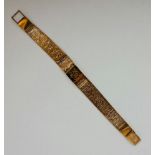 A hallmarked 9ct yellow gold mesh link bracelet, featuring a central panel with engraved monogram,