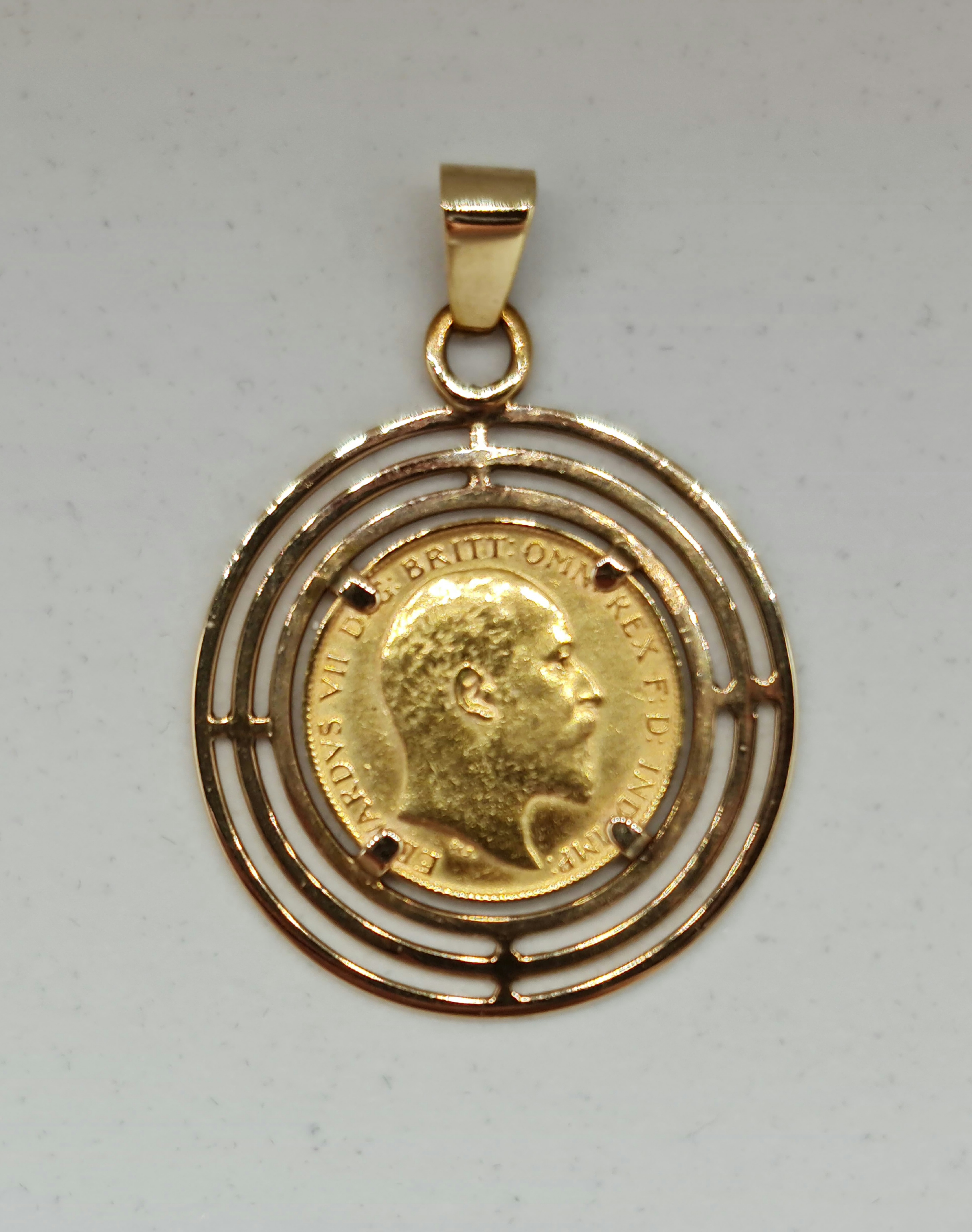 An Edward VII 1902 half sovereign, mounted in open metalwork pendant mount, stamped 9ct, total lot